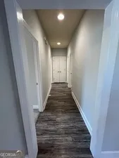 a view of a room with wooden floor