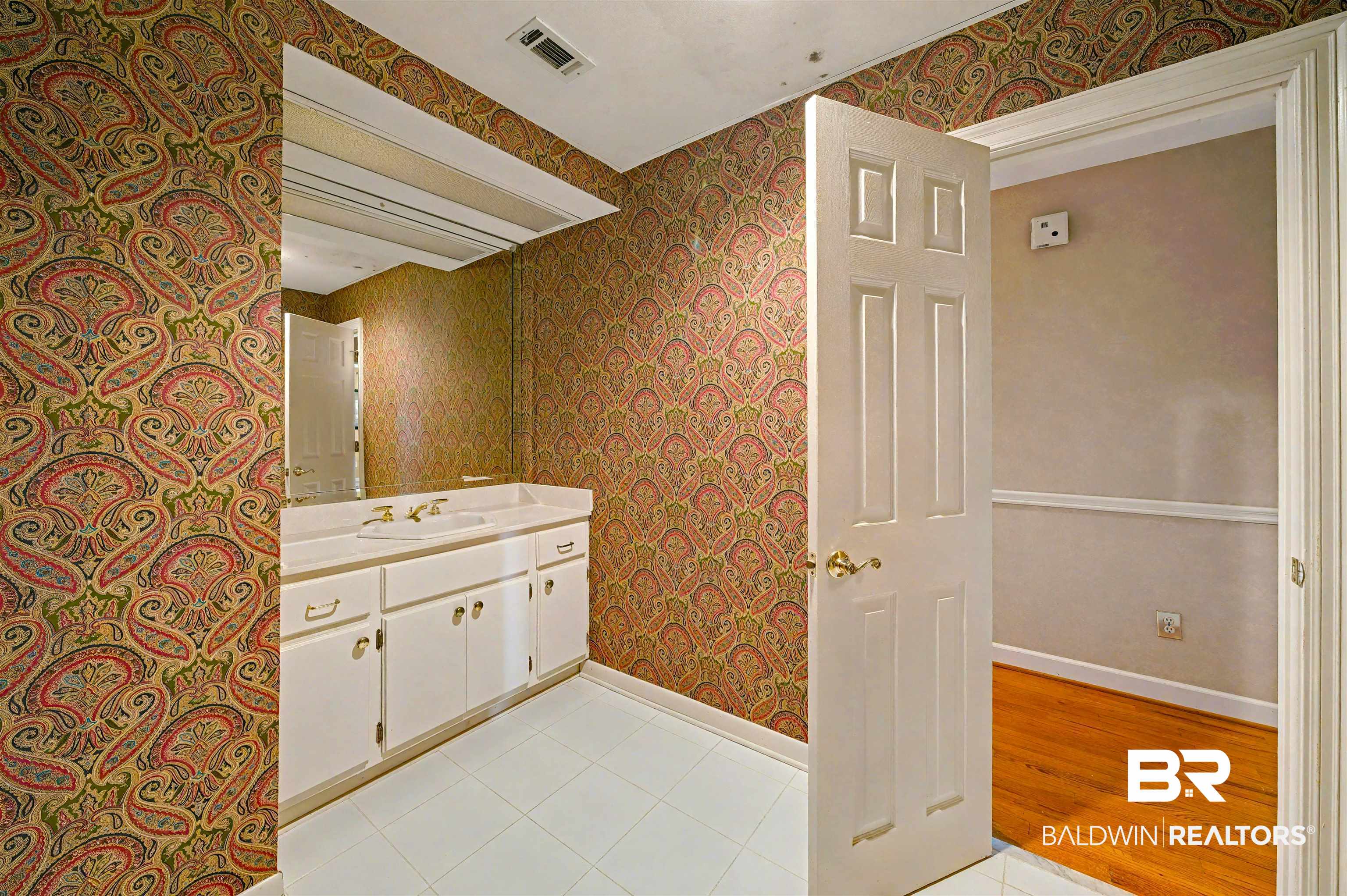 15810 County Road 73 Foley, AL 36535 - Photo 38 of 56 Bathroom with vanity, wallpapered walls, and light tile patterned flooring