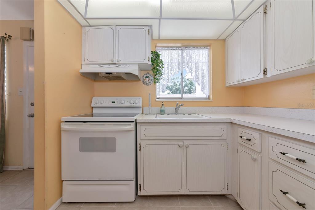 5912 Palm Lane, Unit C36 Bradenton, FL 34207 - Photo 11 of 34 a kitchen with white cabinets and white appliances