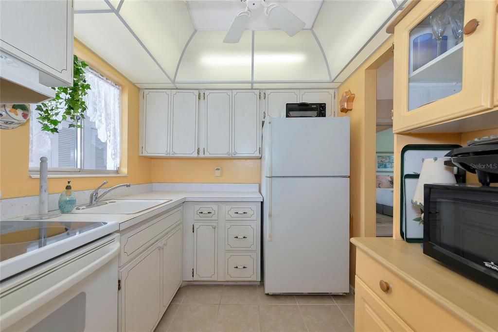 5912 Palm Lane, Unit C36 Bradenton, FL 34207 - Photo 12 of 34 a kitchen with cabinets stainless steel appliances and a counter space