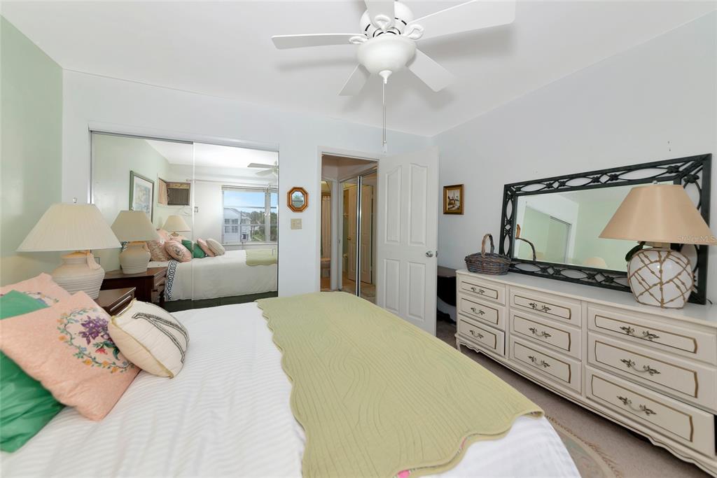 5912 Palm Lane, Unit C36 Bradenton, FL 34207 - Photo 15 of 34 a bedroom with a large bed and a chandelier