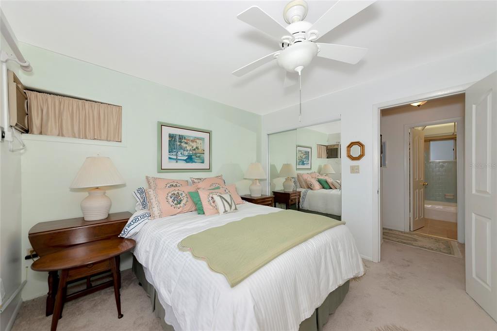 5912 Palm Lane, Unit C36 Bradenton, FL 34207 - Photo 16 of 34 a bedroom with a bed and a chandelier