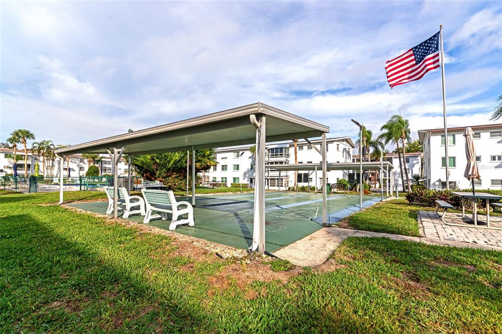 5912 Palm Lane, Unit C36 Bradenton, FL 34207 - Photo 29 of 34 a view of a chair and tables in the garden