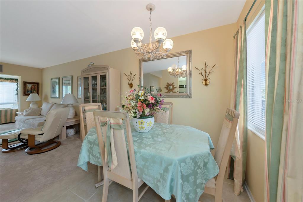 5912 Palm Lane, Unit C36 Bradenton, FL 34207 - Photo 7 of 34 a view of a dining room with furniture and a chandelier