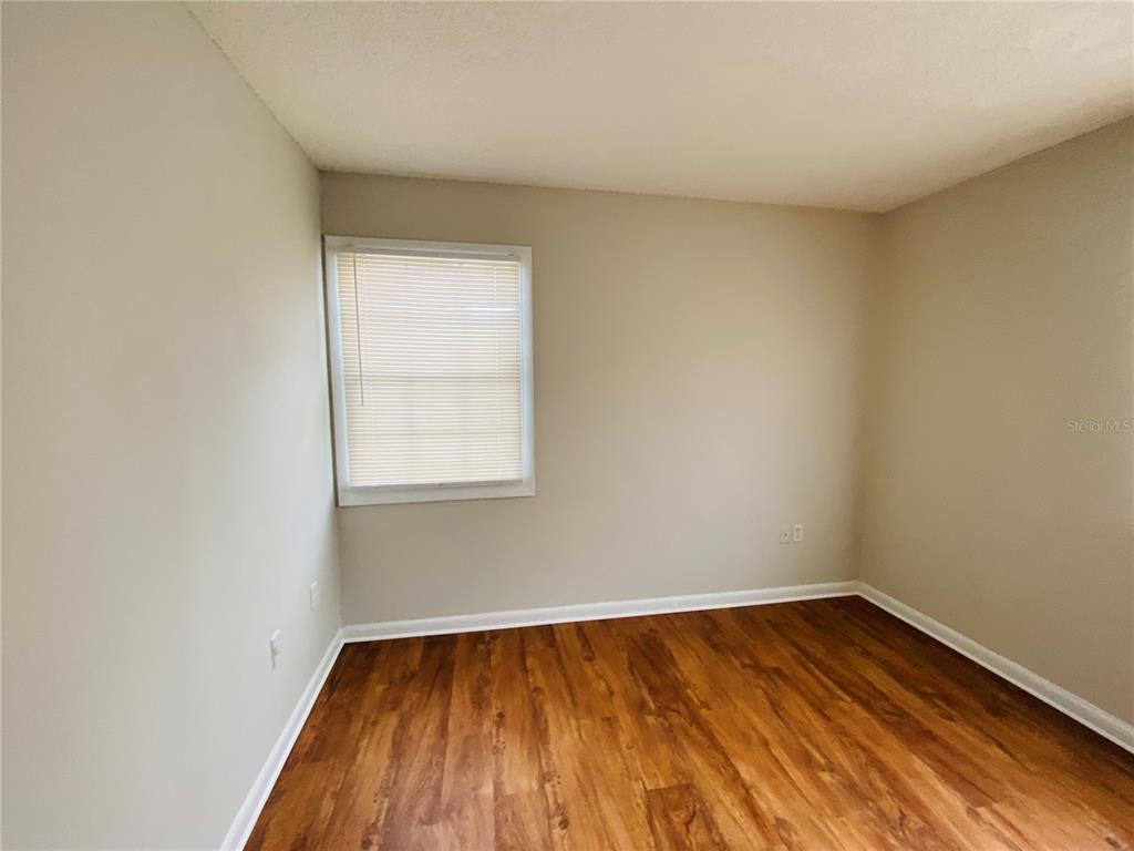 2757 L B McLeod Road, Unit C Orlando, FL 32805 - Photo 16 of 23 a view of a room with wooden floor and window