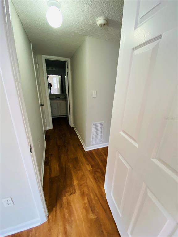 2757 L B McLeod Road, Unit C Orlando, FL 32805 - Photo 19 of 23 a view of a hallway with wooden floor and staircase