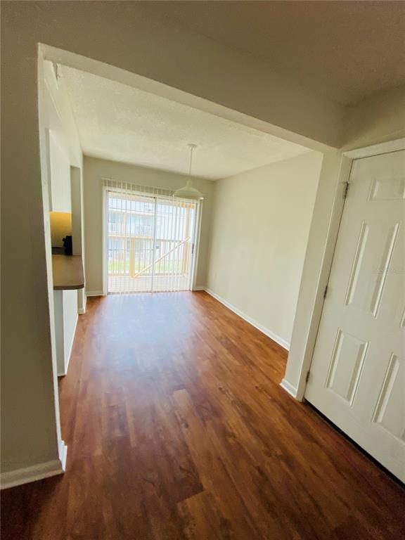 2757 L B McLeod Road, Unit C Orlando, FL 32805 - Photo 8 of 23 an empty room with wooden floor and windows