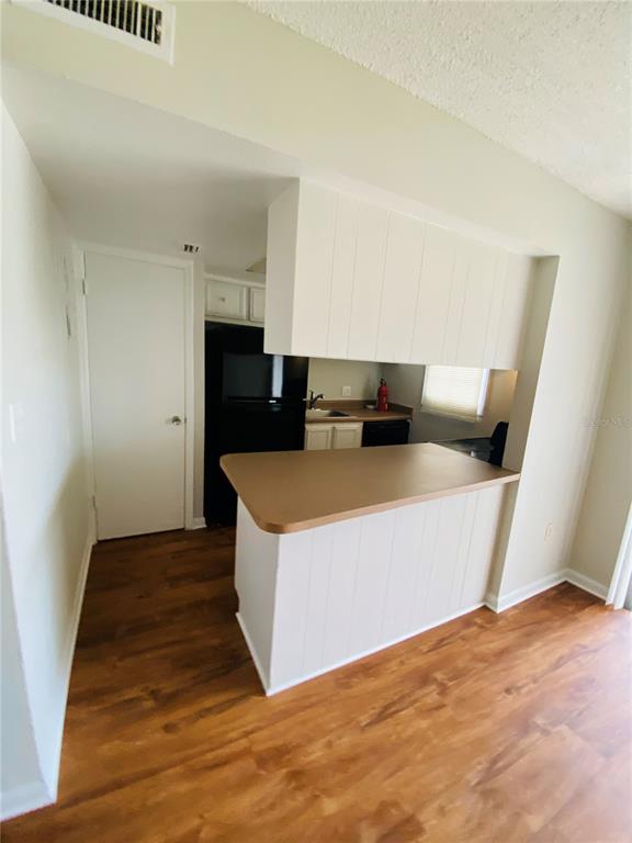 2757 L B McLeod Road, Unit C Orlando, FL 32805 - Photo 10 of 23 a view of a kitchen with microwave and cabinets