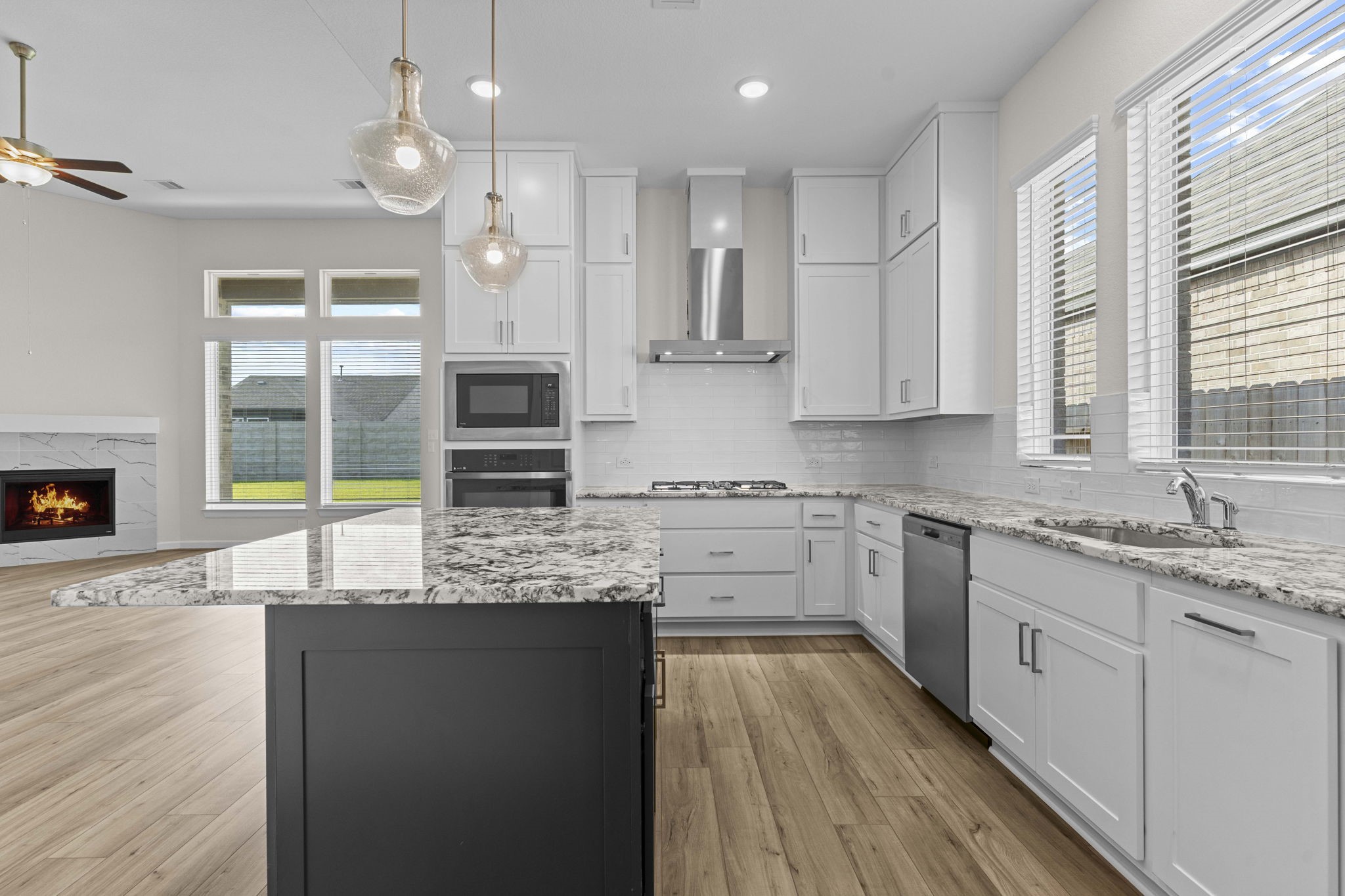 603 Debbie Court Rosharon, TX 77583 - Photo 13 of 26 a kitchen with stainless steel appliances granite countertop a stove a sink and white cabinets with wooden floor