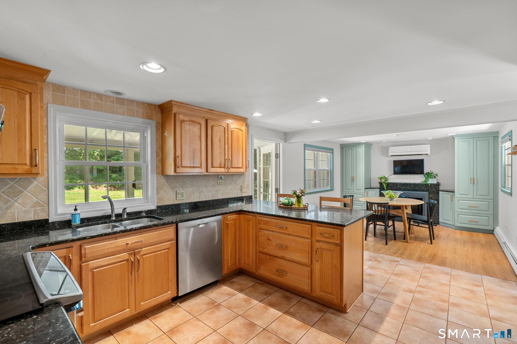14 Richard Road Simsbury, CT 06070 - Photo 15 of 40 kitchen looking into the eat in area with wood burning fireplace and built-ins.
