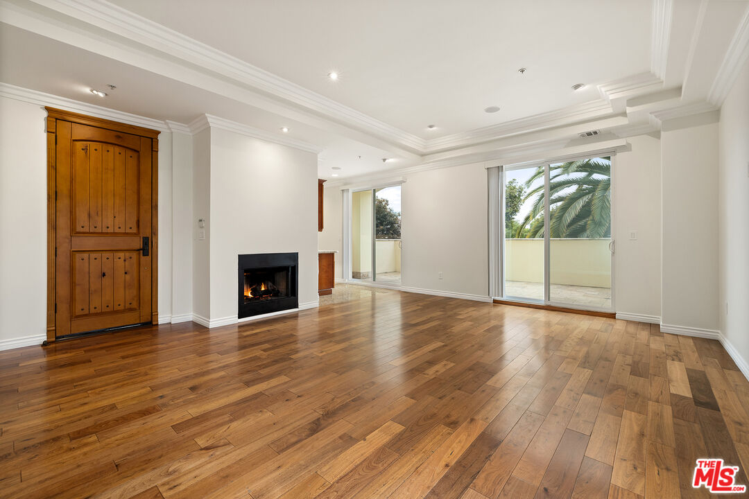 632 North Kings Road, Unit 201 West Hollywood, CA 90048 - Photo 1 of 14 a view of empty room with wooden floor and fireplace