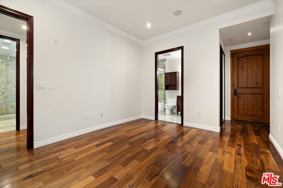 632 North Kings Road, Unit 201 West Hollywood, CA 90048 - Photo 9 of 14 a view of an empty room with wooden floor and a window
