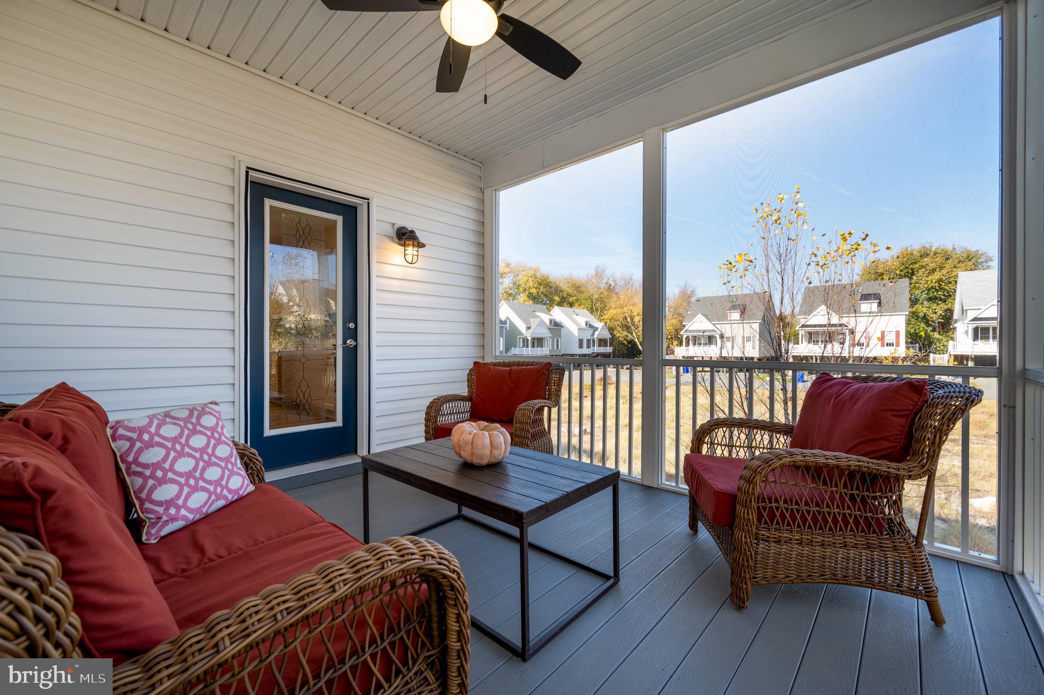31311 Point Reyes Lane, Unit 15 Ocean View, DE 19970 - Photo 17 of 32 a living room with furniture and a floor to ceiling window