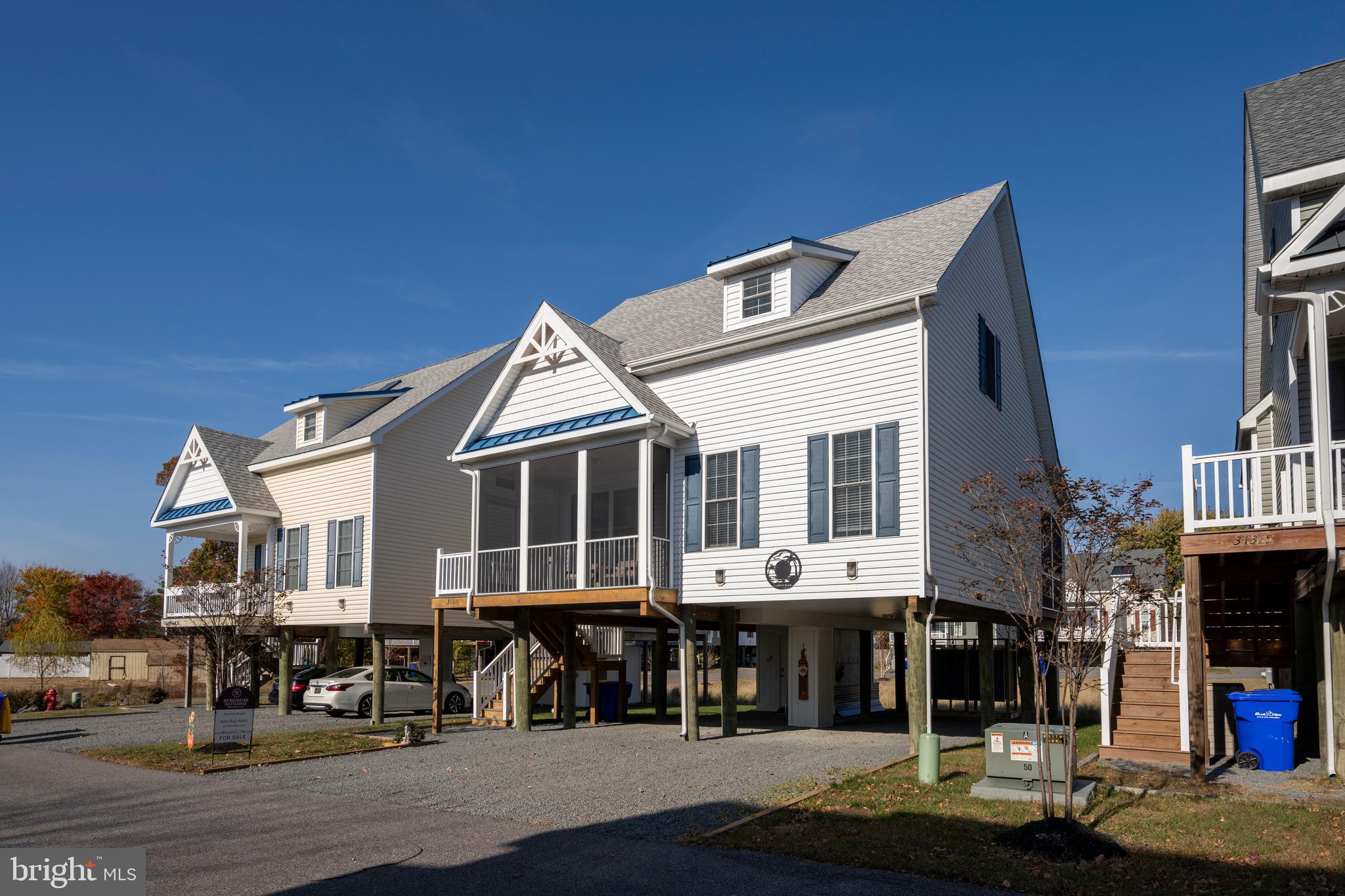31311 Point Reyes Lane, Unit 15 Ocean View, DE 19970 - Photo 2 of 32 a front view of a house with a yard