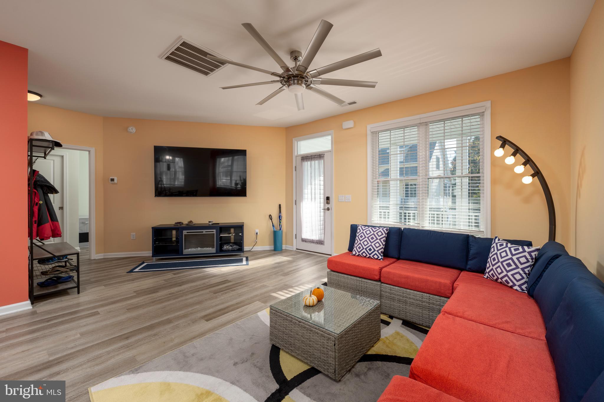 31311 Point Reyes Lane, Unit 15 Ocean View, DE 19970 - Photo 4 of 32 a living room with fireplace furniture and a flat screen tv