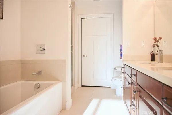 a bathroom with a granite countertop sink a mirror and a bathtub