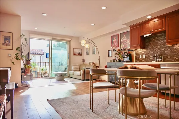 a living room with furniture a rug and a large window