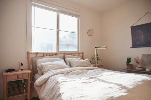 a bedroom with a bed and a window