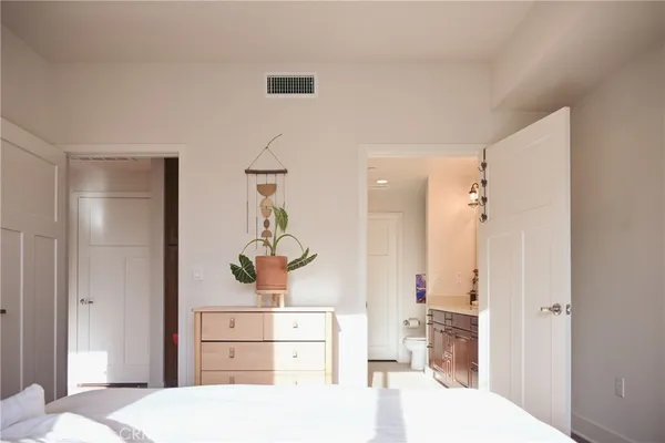 a bedroom with a bed and cabinets