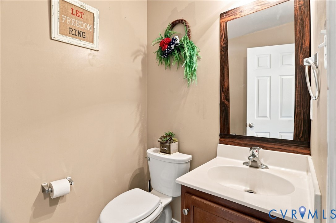 6401 Poplar Road Quinton, VA 23141 - Photo 14 of 46 Powder room featuring a wood-framed mirror, vanity