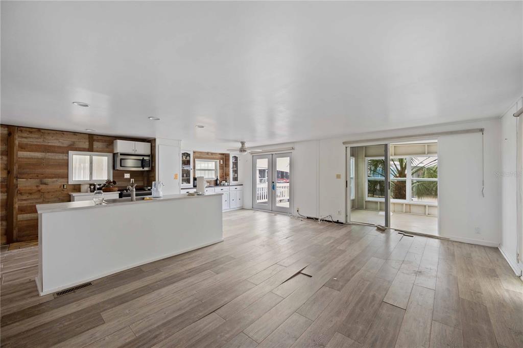 10303 Burnt Store Road, Unit 131 Punta Gorda, FL 33950 - Photo 3 of 25 a room with wooden floors and kitchen view