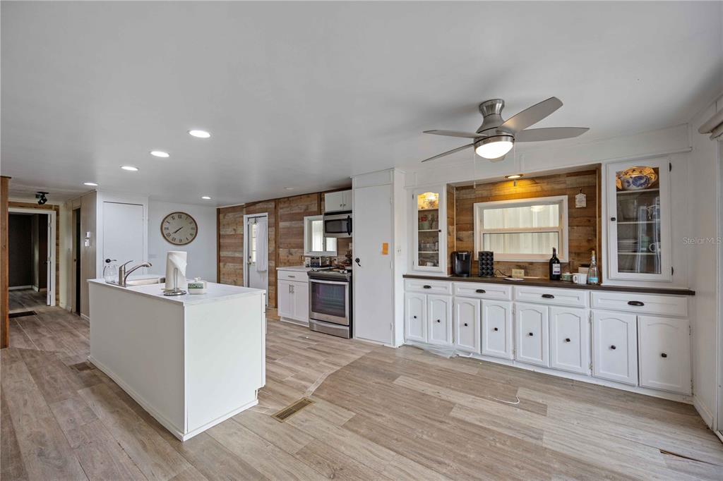 10303 Burnt Store Road, Unit 131 Punta Gorda, FL 33950 - Photo 5 of 25 a living room with granite countertop furniture a fireplace a flat screen tv and a dresser