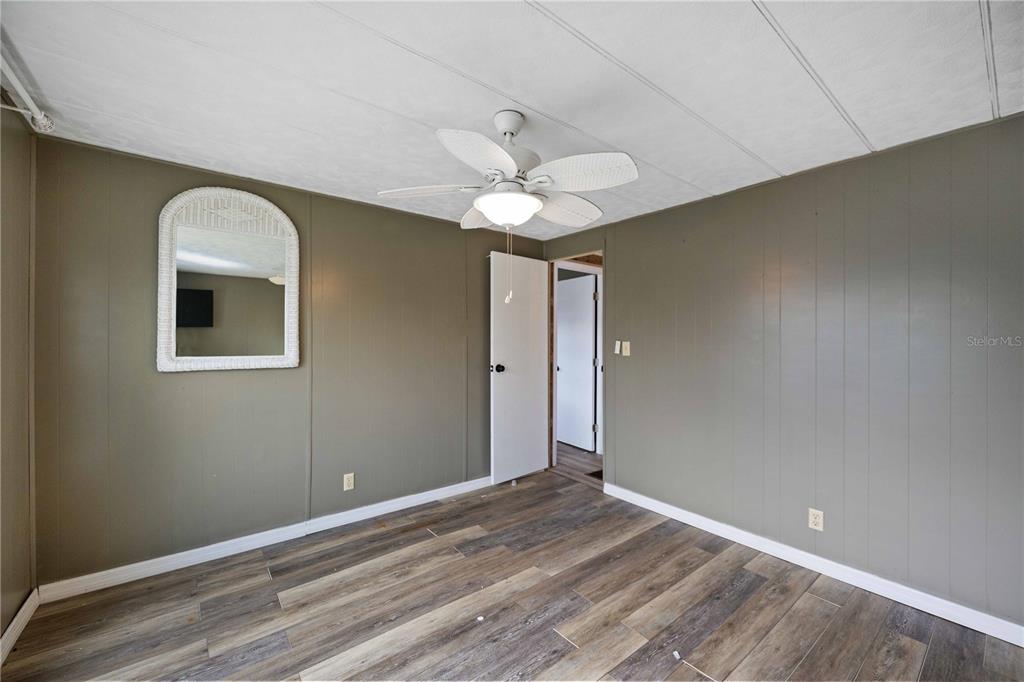 10303 Burnt Store Road, Unit 131 Punta Gorda, FL 33950 - Photo 10 of 25 wooden floor in an empty room