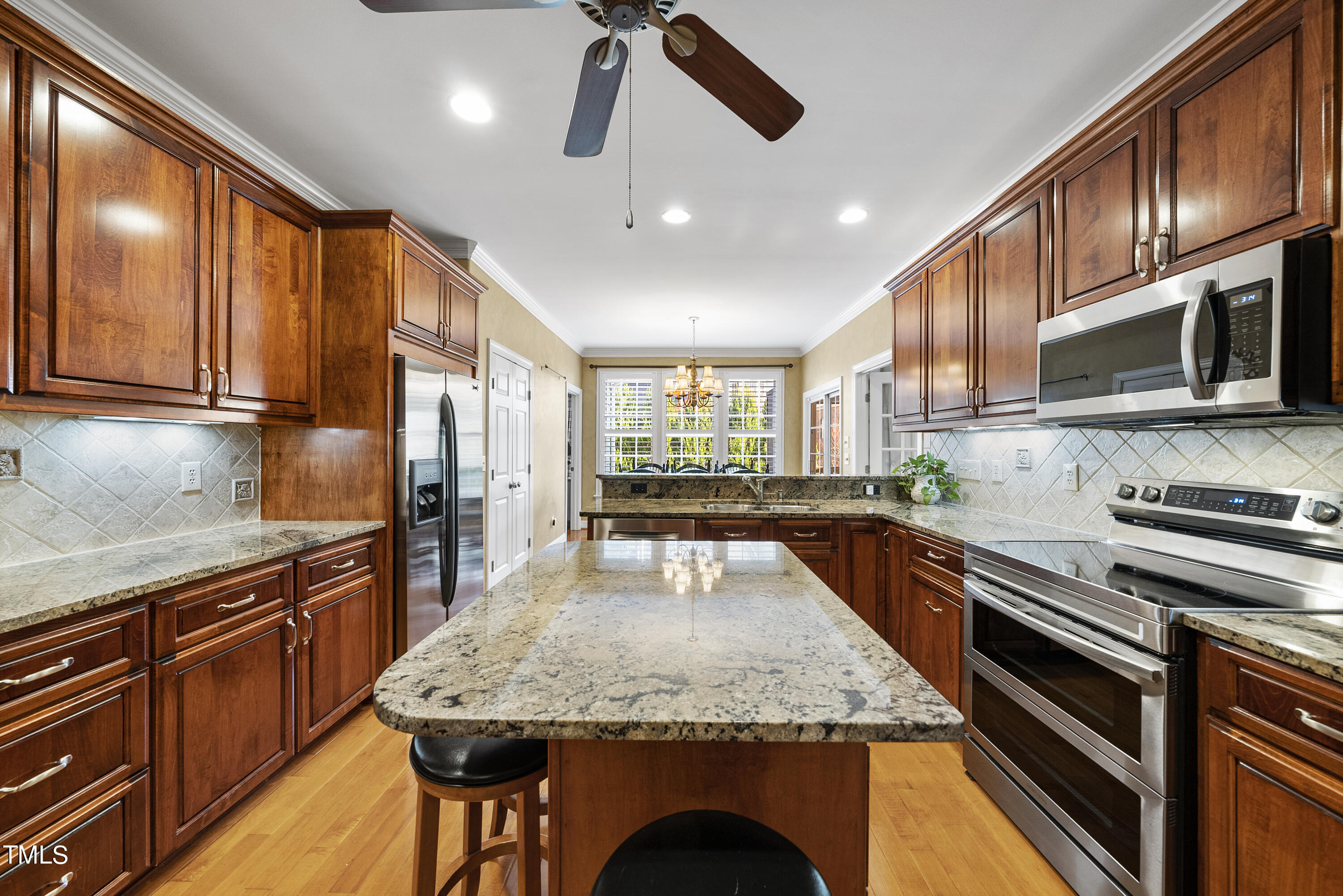 12740 Rosalie Street Raleigh, NC 27614 - Photo 20 of 43 a kitchen with stainless steel appliances granite countertop wooden cabinets granite counter tops and a stove
