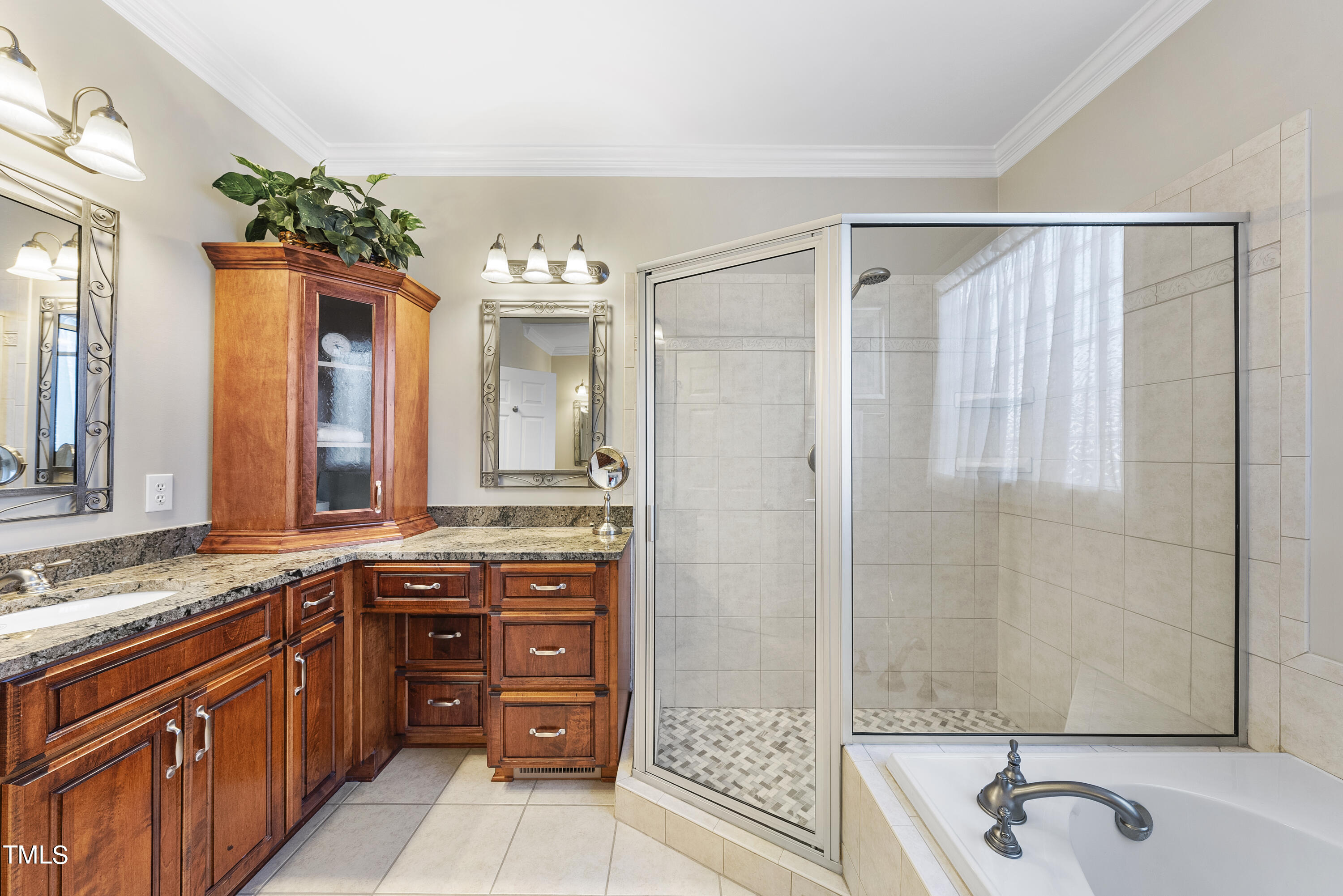 12740 Rosalie Street Raleigh, NC 27614 - Photo 26 of 43 a bathroom with a granite countertop sink a large mirror and a bathtub