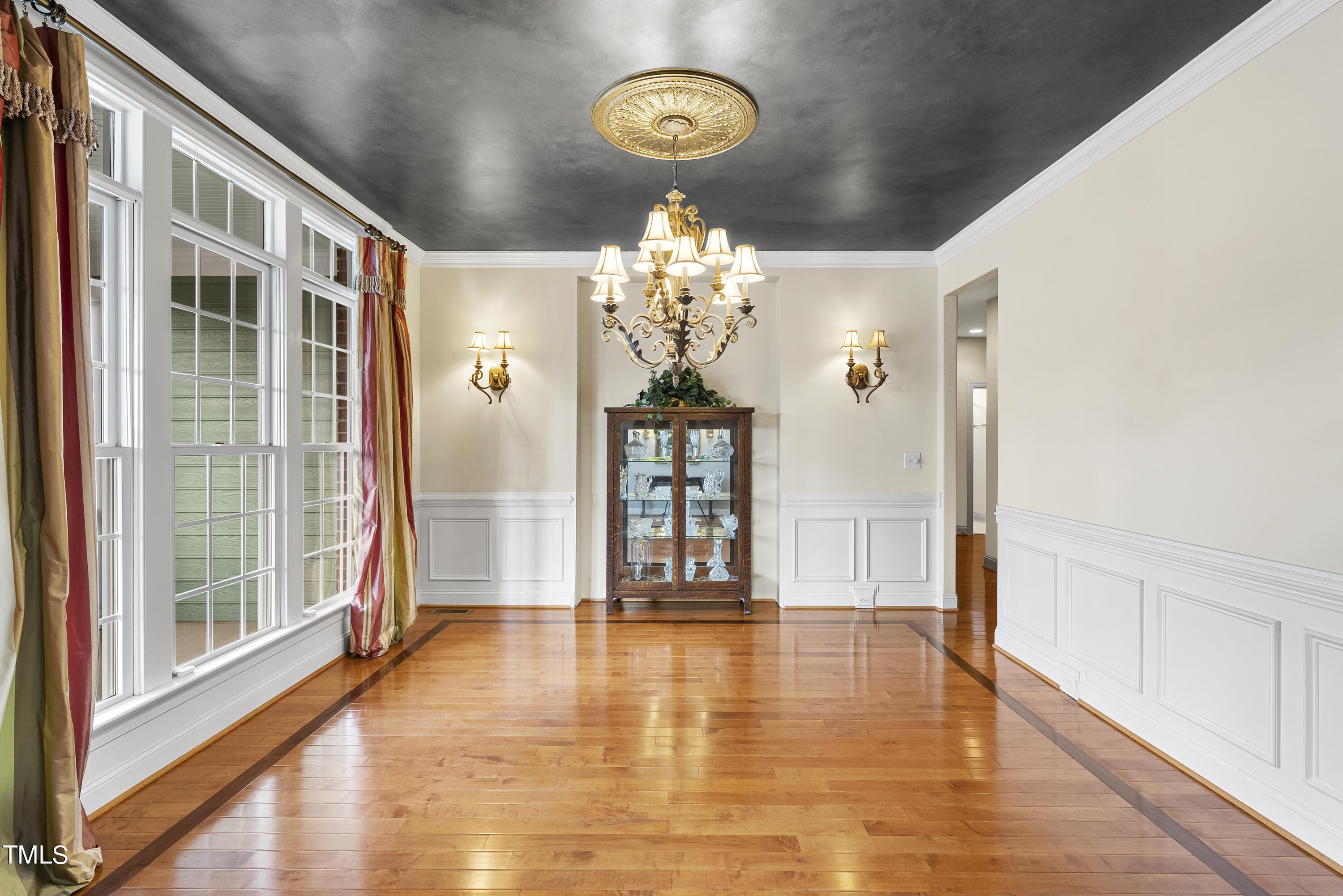 12740 Rosalie Street Raleigh, NC 27614 - Photo 4 of 43 a view of a hallway with wooden floor and chandelier