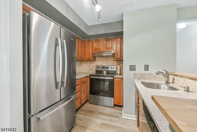 83 Mayfield Road, Unit 83 Bedminster, NJ 07921 - Photo 4 of 9 a kitchen with a refrigerator sink and stove