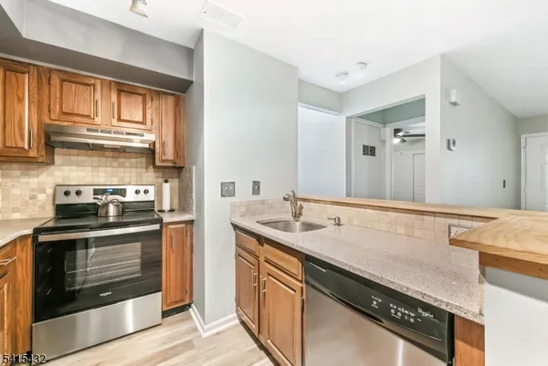 a kitchen with a sink stove and cabinets
