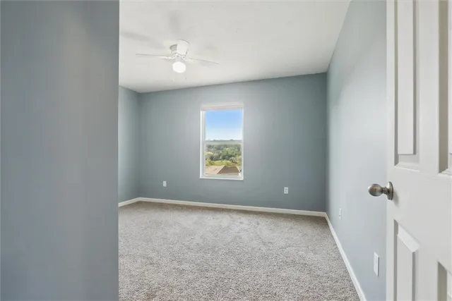 a view of room with window and ceiling fan