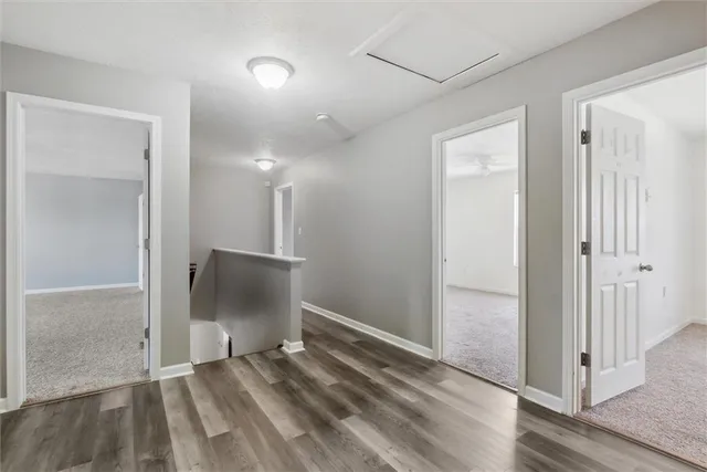 a view of a room with wooden floor and windows