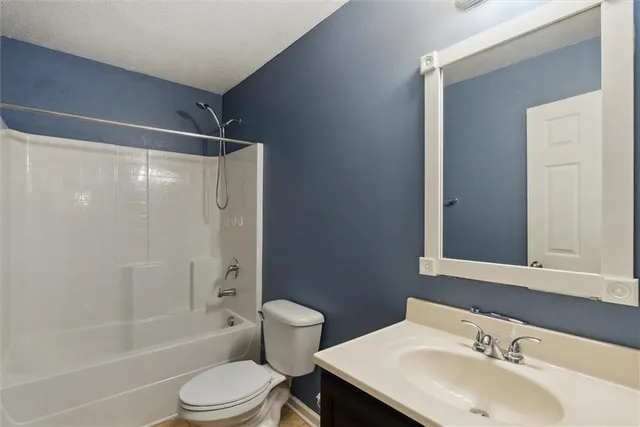 a bathroom with a toilet a sink and shower