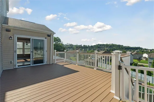 a view of a house with backyard and deck