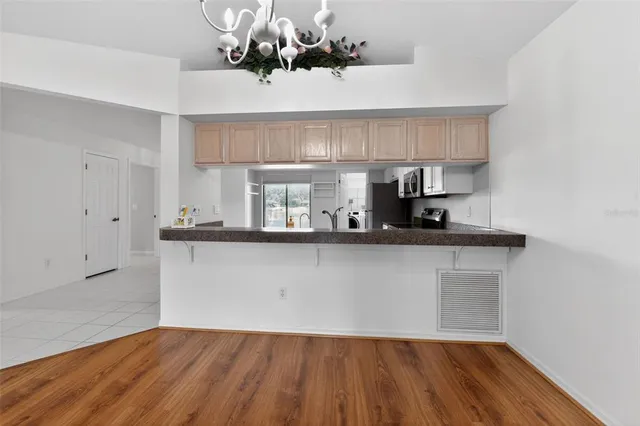 a view of a room with wooden floor and window