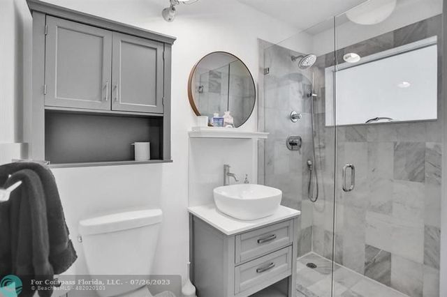 a bathroom with a toilet a sink and a mirror