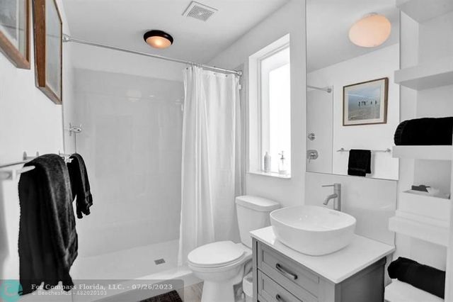 a bathroom with a toilet a sink and a mirror