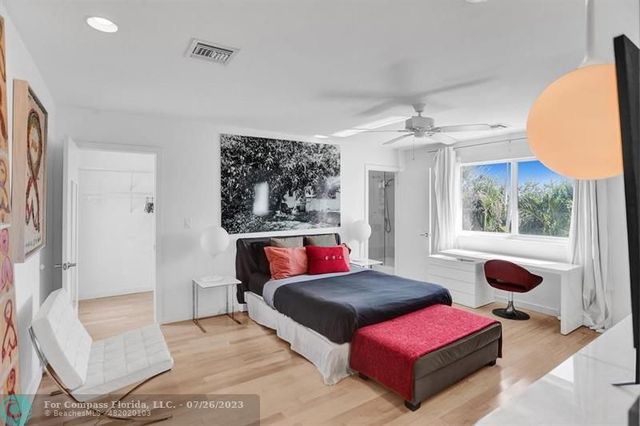 a bedroom with furniture and a large window