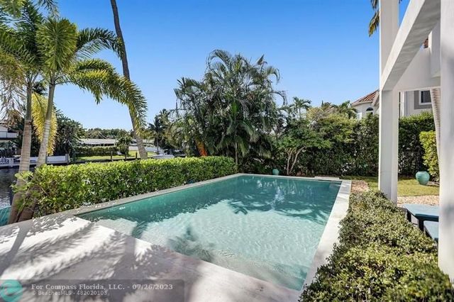 a view of a swimming pool with a yard