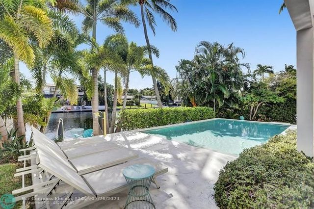 a view of a backyard with swimming pool