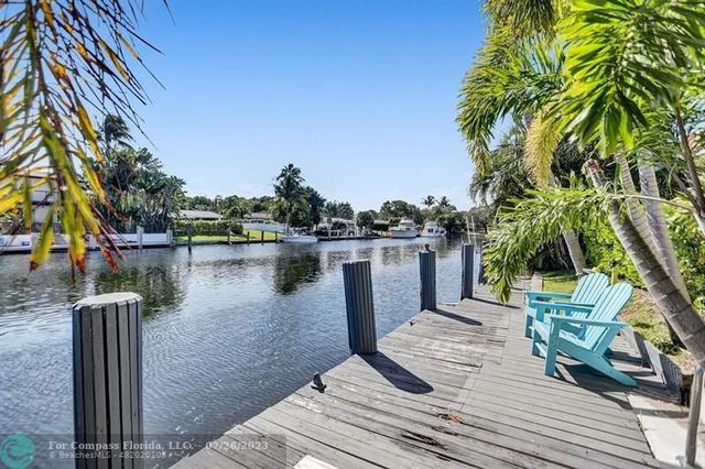 a view of a lake with boats and palm trees