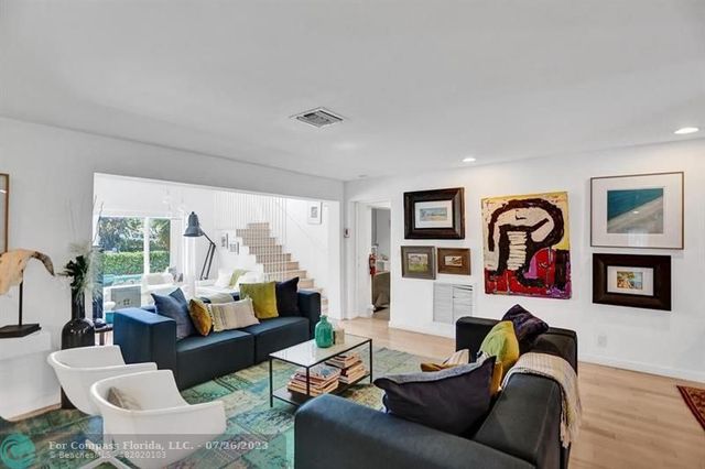 a living room with furniture fireplace and window