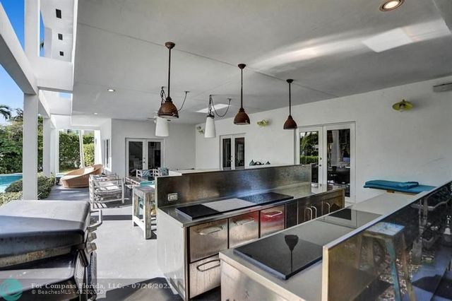 a kitchen with stainless steel appliances granite countertop a sink a stove and a wooden floors