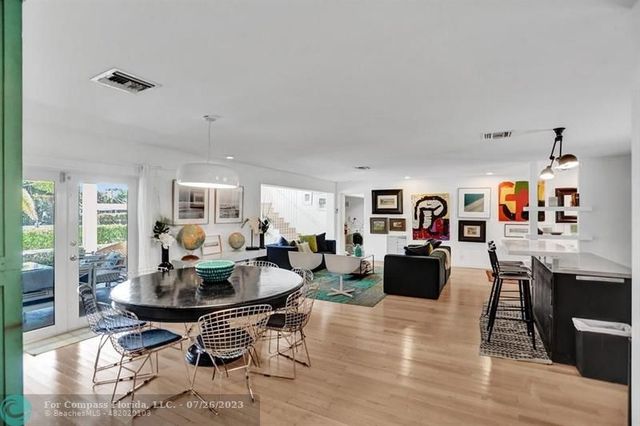 a living room with fireplace furniture and a wooden floor