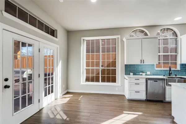 a view of a kitchen with stainless steel appliances granite countertop a stove and a window