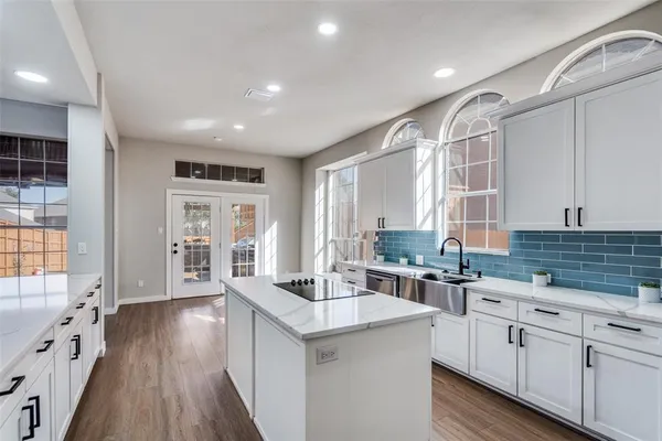 a kitchen with counter top space a sink cabinets and appliances