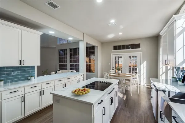 a kitchen with granite countertop a sink stove and cabinets