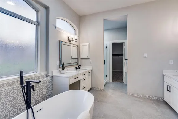 a spacious bathroom with a double vanity sink a mirror and a shower